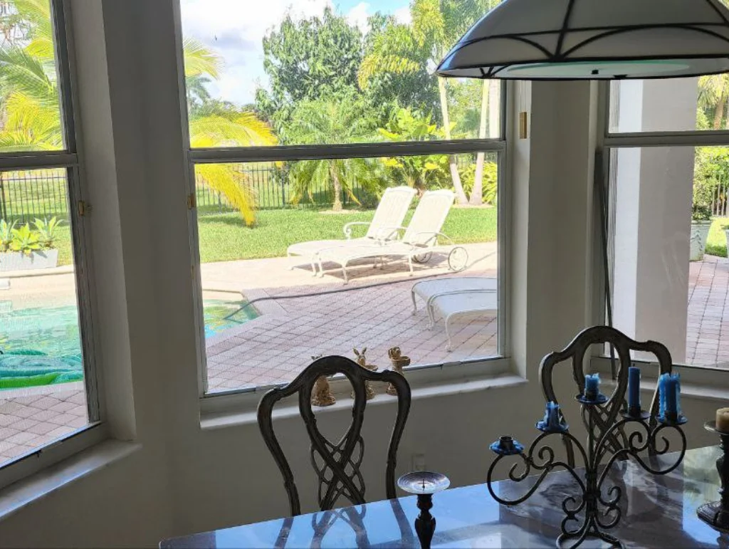 Living room window overlooking a lawn and waterfront