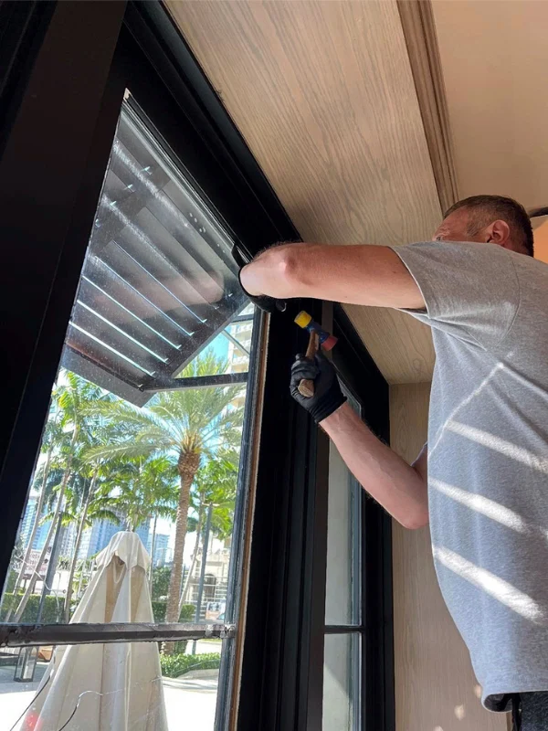 Technician peeling protective film off a new sliding glass door
