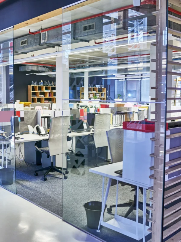 Office workspace seen through interior glass partition walls