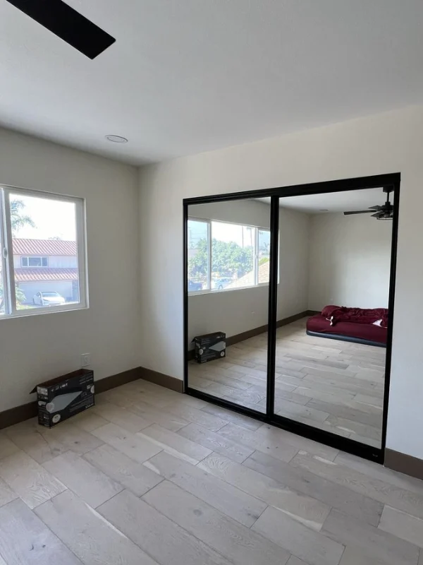 Empty room with a black-framed glass door and window